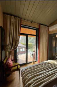 a bedroom with a bed and a large window at Хлеча house in Stantsiya Korchi +15 photos