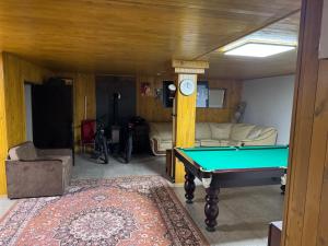 a living room with a pool table in it at Хлеча house in Stantsiya Korchi