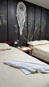 a bedroom with two beds and a wall at Red Frog Rooms in Fortuna +54 photos