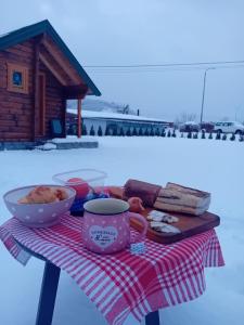 a table with a plate of food and a bowl of food at Vojinov kutak in Mojkovac +41 photos