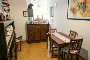 a kitchen with a table and chairs and a kitchen with a counter at B&B Orchard in Viterbo
