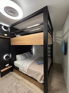 a bedroom with a bunk bed with a ceiling at Lelo Sunset Spa, Romantic Garden Apartment with Private Jacuzzi in Zadar