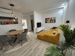 a living room with a couch and a table at Lelo Sunset Spa, Romantic Garden Apartment with Private Jacuzzi in Zadar