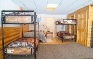 a room with three bunk beds in a room at Forest Glade in Sturgis