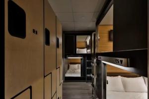 a small room with two beds and a hallway at Hygie Boutique Hotel in Montreal