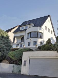 a large white house with a garage at Rheinvilla Weitblick in Boppard