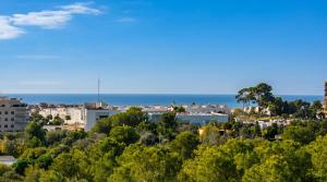 a view of a city with the ocean in the background at Villa Med A 2 kilometros andando de la playa, del puerto de Aguadoç y a 4 del centro de Sitges Muy Soleada todo el dia Capacidad superior a 16 personas NO REQUIERE COCHE in Sitges