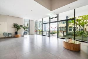 a large room with glass windows and a table at Luxury 3BR Sea View and Pool in Tel Aviv