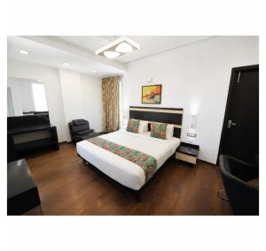 a hotel room with a bed and a piano at Purple Brigade, Bangalore in Bangalore +31 photos
