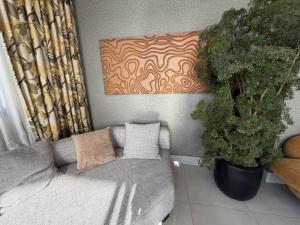 a living room with a couch and some plants at 1B in Naco Jacuzzi very Centric in Santo Domingo