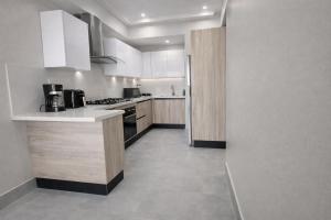 a kitchen with white cabinets and a counter top at 1B in Naco Jacuzzi very Centric in Santo Domingo