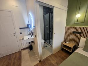 a small bathroom with a toilet and a sink at Hostal Main Street Madrid in Madrid