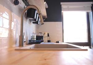 a kitchen counter with a sink and a window at Francisco Vau Apartment in Portimão +24 photos