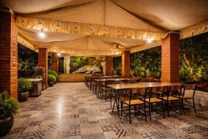 a restaurant with tables and chairs in a room at Amber Resort in Sasan Gir