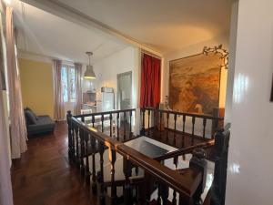 a living room with a staircase and a painting on the wall at Garden suite / del ducato in Parma