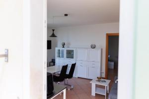 a living room with a table and chairs at Casa Giordana in Torri del Benaco