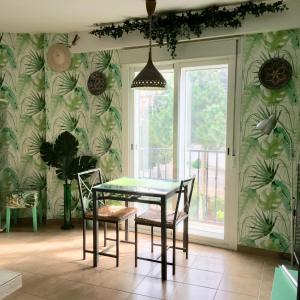 a dining room with a table and chairs and a window at One bedroom penthouse in Alora