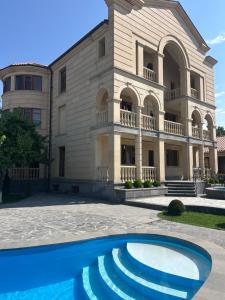 a building with a pool in front of it at Waterfall home in Yerevan