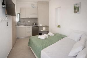 a bedroom with a large bed with towels on it at Yalos Tiny Studio - 5 mins to Elafonisi beach in Agios Padeleimon