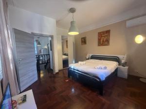a bedroom with a bed with two towels on it at Garden suite / del ducato in Parma