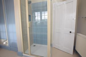 a shower with a glass door in a bathroom at 2 Bed in Biddenden oc-cb616 in Biddenden +7 photos