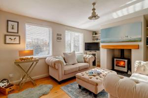 a living room with two couches and a fireplace at 4 Bed in Westleton oc-s27303 in Westleton