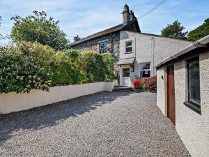 a stone house with a driveway in front of it at 2 Bed in Keswick oc-sz145 in Braithwaite