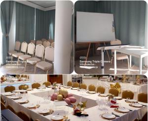 a conference room with white tables and chairs and a screen at Hotel Villa Hubertus Kutno in Kutno
