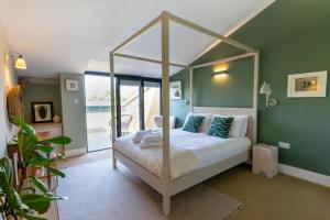 a bedroom with a bed with a canopy at 3 Bed in Henham oc-3nvf in Wangford