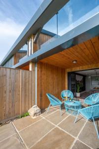 an outdoor patio with blue chairs and a table at 3 Bed in Henham oc-3nvf in Wangford