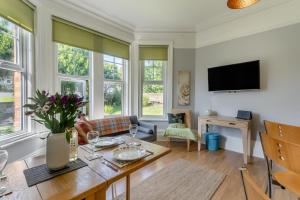 a living room with a table and a tv at 2 Bed in Bexhill-on-Sea oc-t29534 in Bexhill