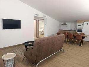 a living room with a couch and a table at Casa rural El Terreno in Teruel