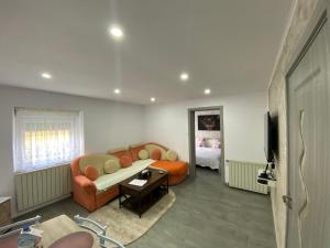 a living room with a couch and a bed at Au refuge de David et Leah in Willer-sur-Thur