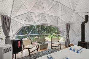 a room with a large glass walled room with a tent at Ferncrest Campground in Greentown +49 photos