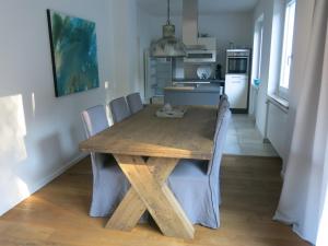 a wooden table and chairs in a kitchen at Rheinvilla Weitblick in Boppard