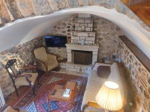 an overhead view of a living room with a stone fireplace at Andromahi Stone House in Stemnitsa