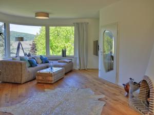 a living room with a couch and a large window at Rheinvilla Weitblick in Boppard