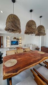 a living room with a wooden table and chairs at Raml villa in Ras al Khaimah