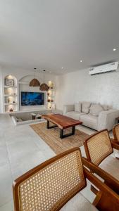 a living room with a couch and a table at Raml villa in Ras al Khaimah