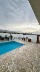 a swimming pool in the middle of a building with at Raml villa in Ras al Khaimah +27 photos