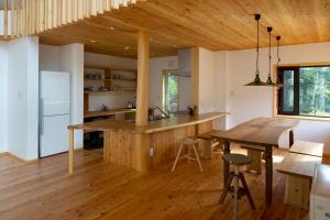 a kitchen with a wooden counter top and a table at Fuku Chalet in Hakuba