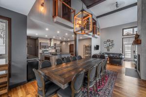 a dining room with a large wooden table and chairs at Blanc40 in Stoneham