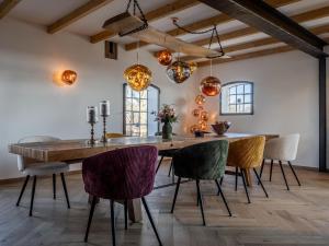 a dining room with a wooden table and chairs at Scheune 1746 in Tating