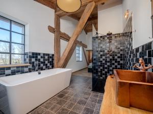 a bathroom with a large tub and a sink at Scheune 1746 in Tating +60 photos