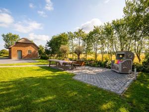 a backyard with a bench and a table and a building at Scheune 1746 in Tating