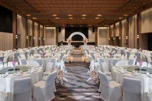 a large banquet hall with white tables and chairs at Sheraton Johor Bahru in Johor Bahru +100 photos