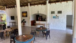 a restaurant with tables and chairs in a room at RodMar Hotel in El Cuco