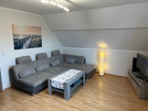 a living room with a couch and a television at Haus Pop in Borkum