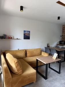 a living room with a couch and a table at Nowa Stodoła in Władysławowo