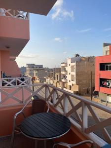 a table and chair on a balcony with buildings at Larriba Santa Maria by RPG Group in Santa Maria